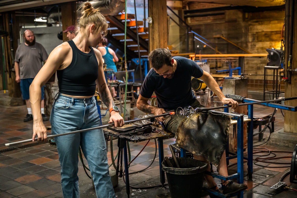 Two other glassblowers in the workshop.